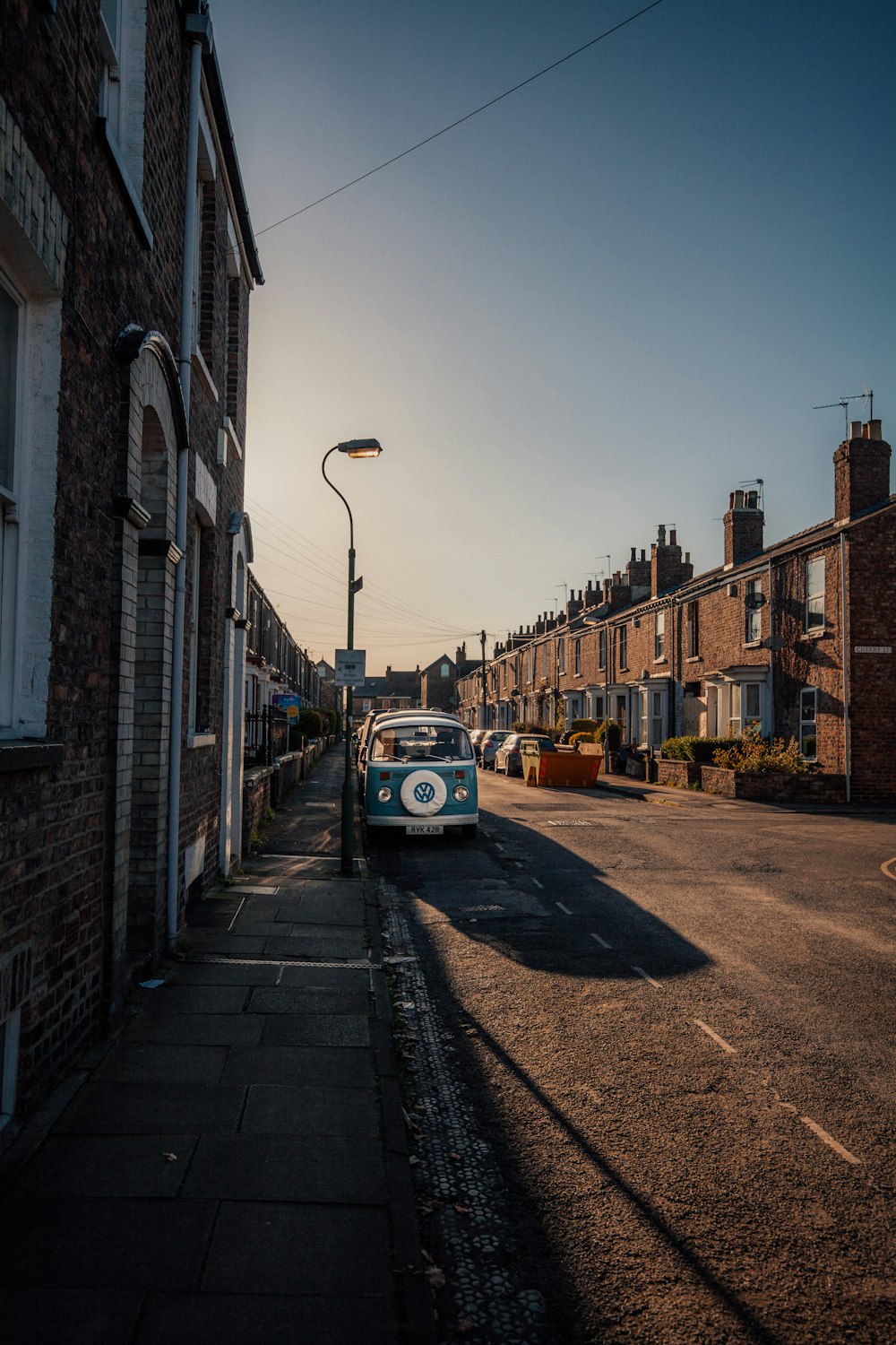 blue Volkswagen van parked on asphalt road