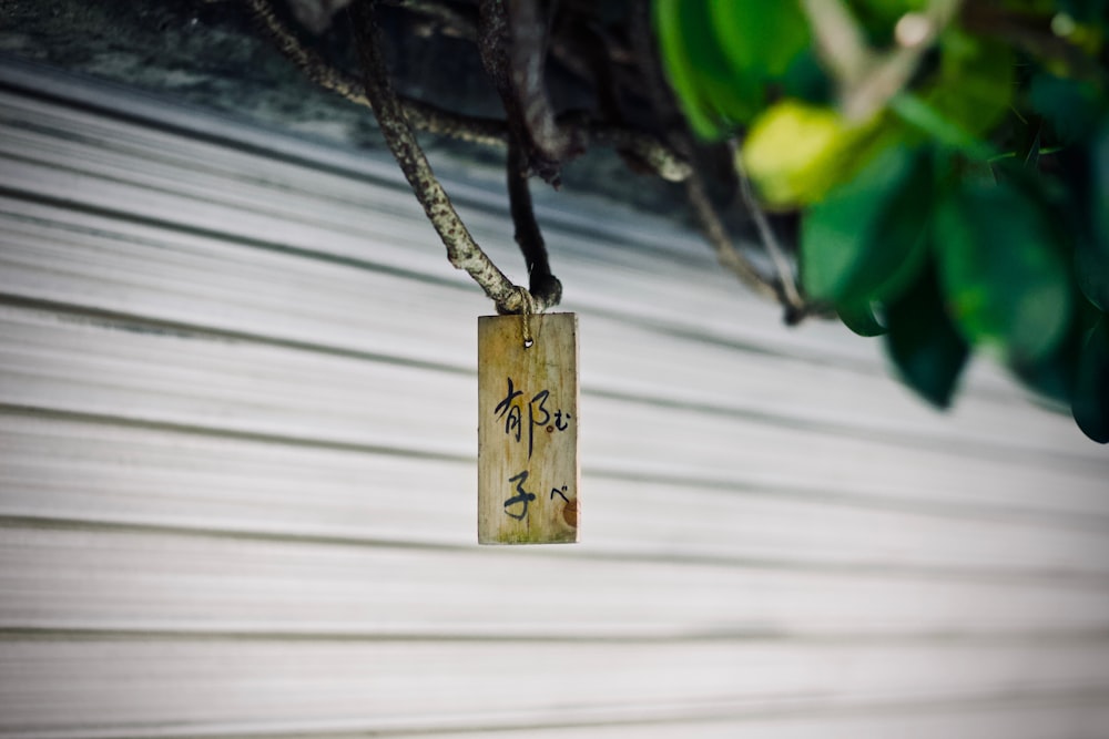 brown wooden decor hanged on twig