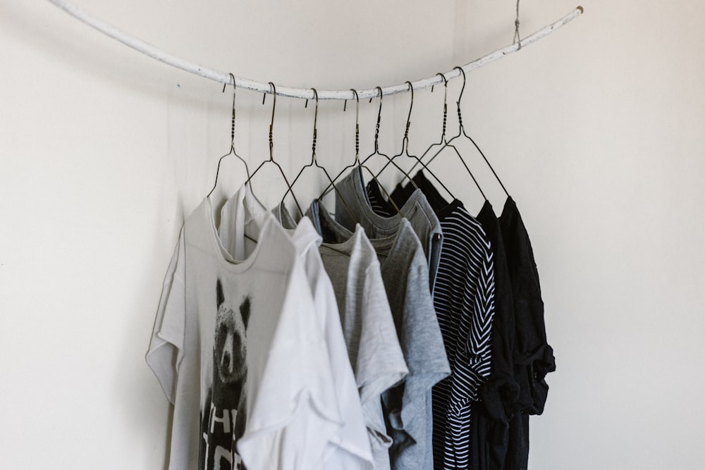assorted-color clothes hanging on rod