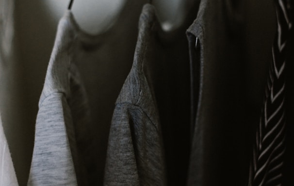 selective focus photography of hanged three gray tee shirts
