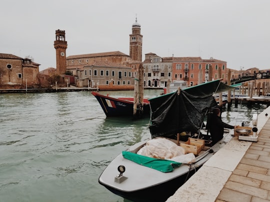 white motorboat parked near dock during daytime in Cometa di Vetro Italy