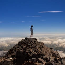 man standing on top of rock formation