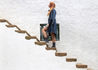 woman climbing on brown concrete stairs