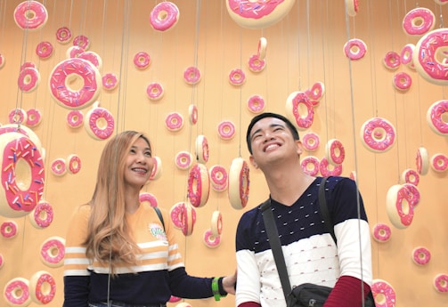 A vibrant donut shop interior with happy customers.