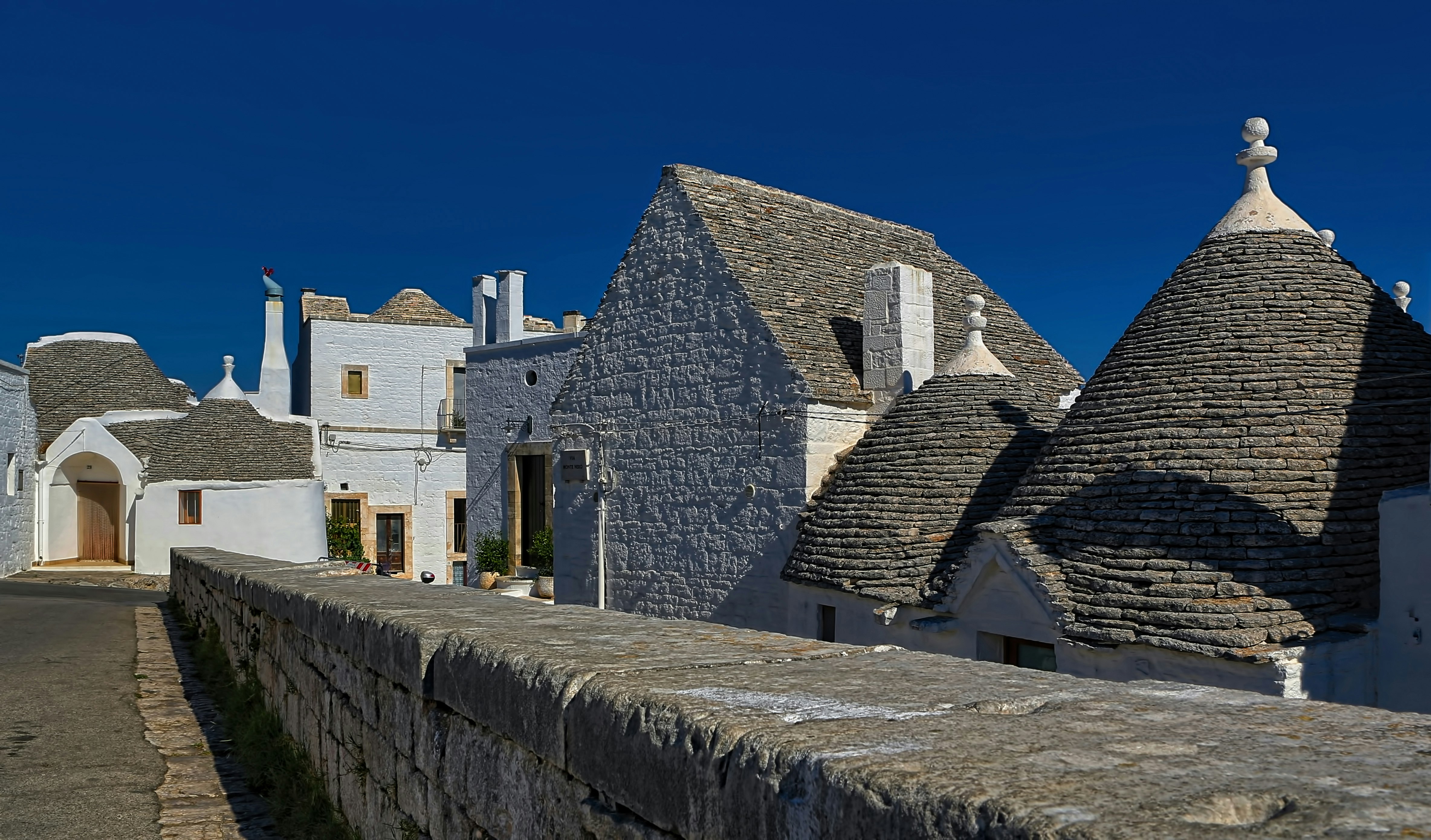 white and gray stone houses near road