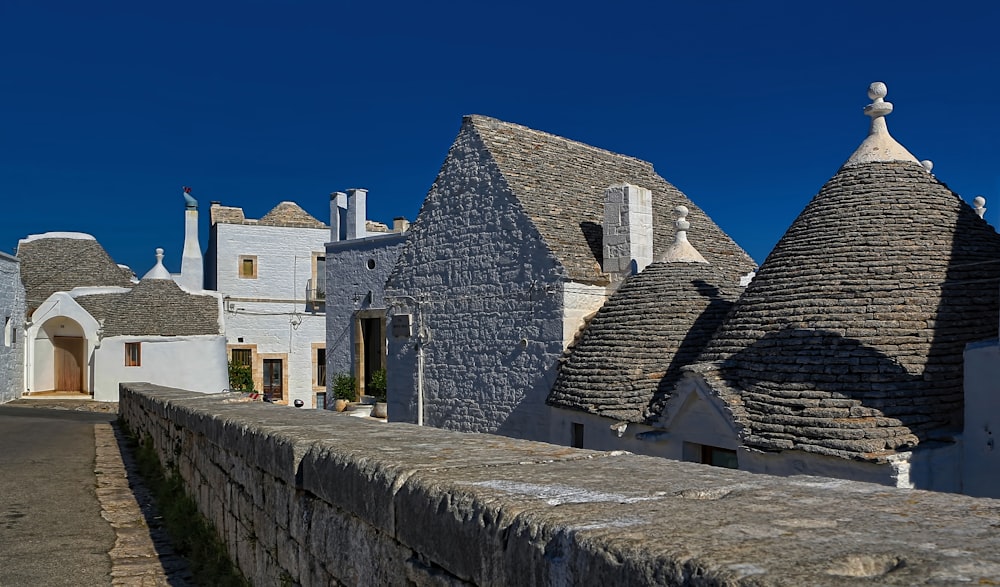 white and gray stone houses near road