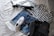 A close-up of a fashionable outfit laid out on a bed with accessories.