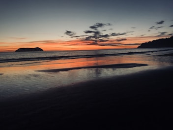 beach shore on horizon of sunset