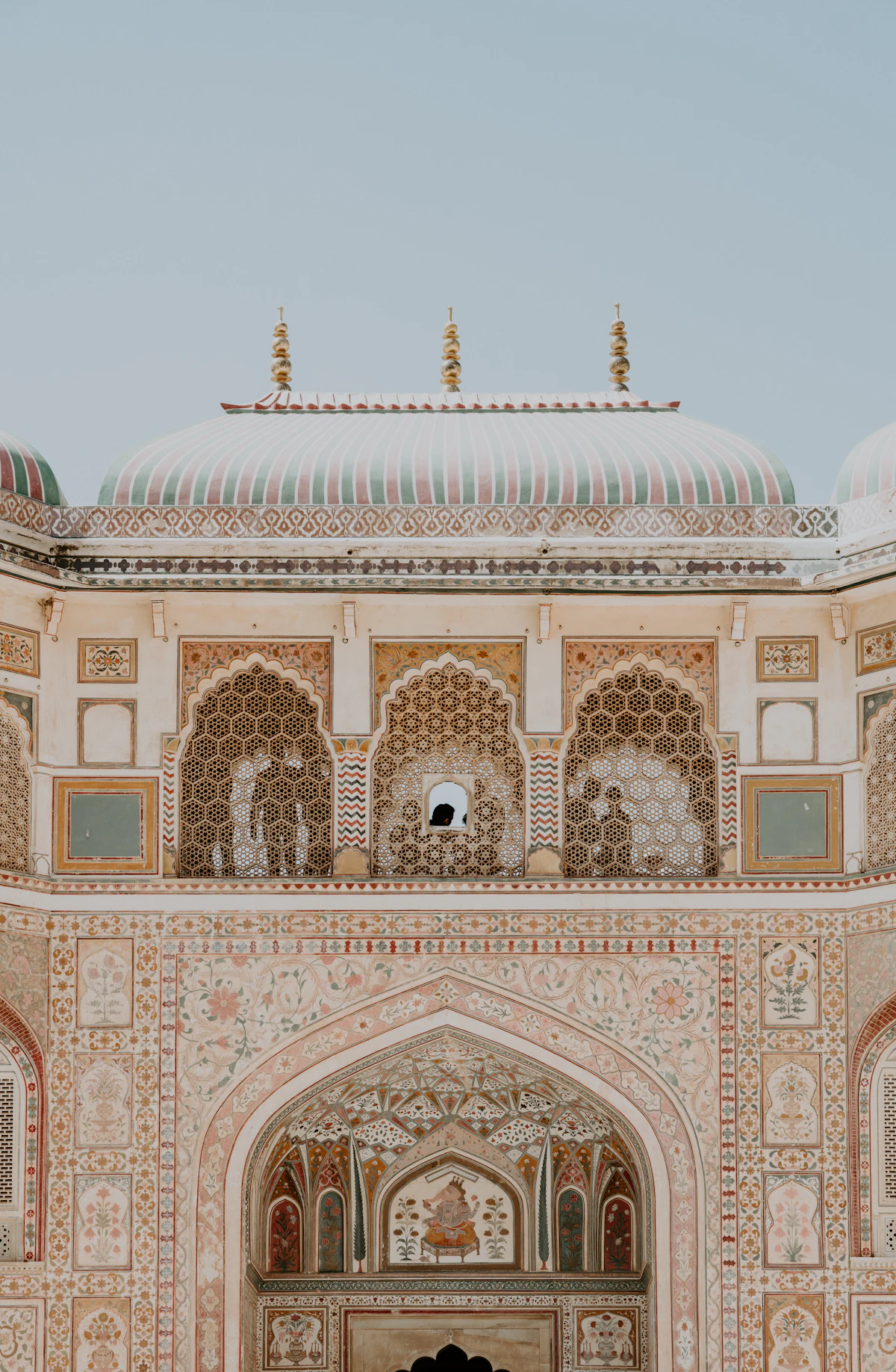 Intricately carved Rajasthani sandstone architecture against a clear sky