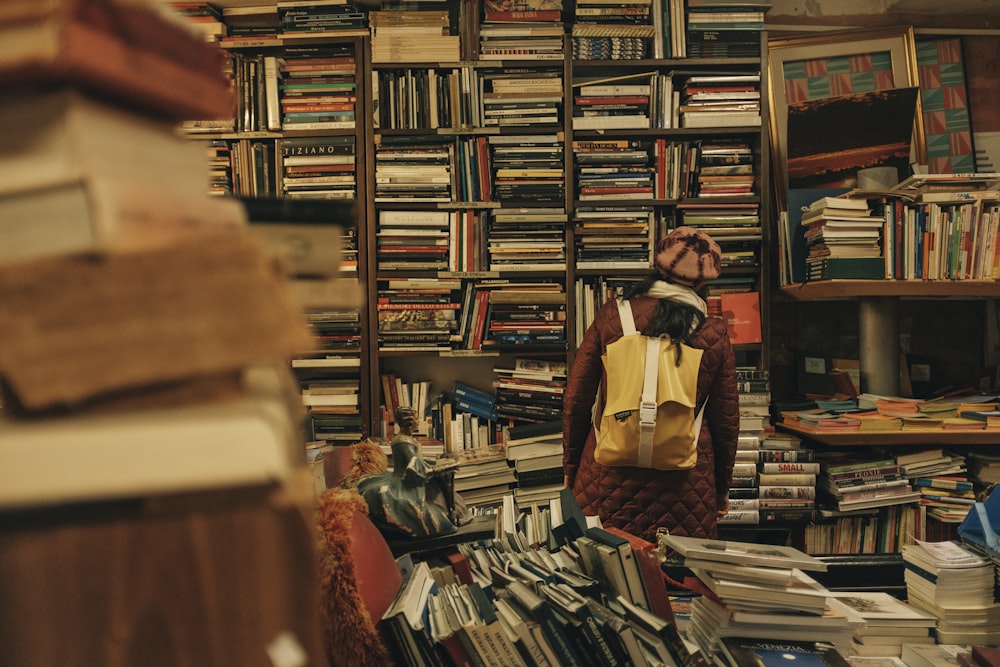 person carrying backpack inside library