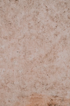a brown wall with a clock on the top of it