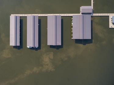 aerial photography of gray roof buildings on body of water