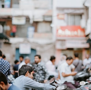 selective focus photo of man riding motorcycle