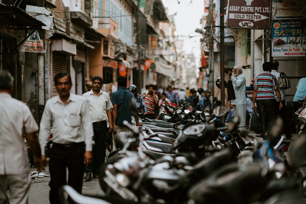 people walking on street near motorcycles