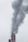 red factory chimney with smoke