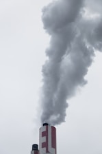 red factory chimney with smoke
