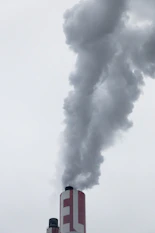 red factory chimney with smoke