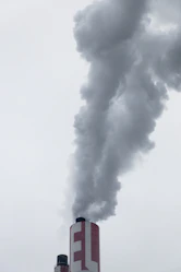red factory chimney with smoke