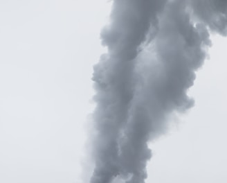 red factory chimney with smoke