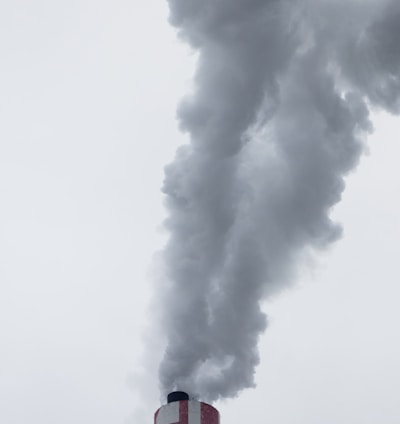 red factory chimney with smoke