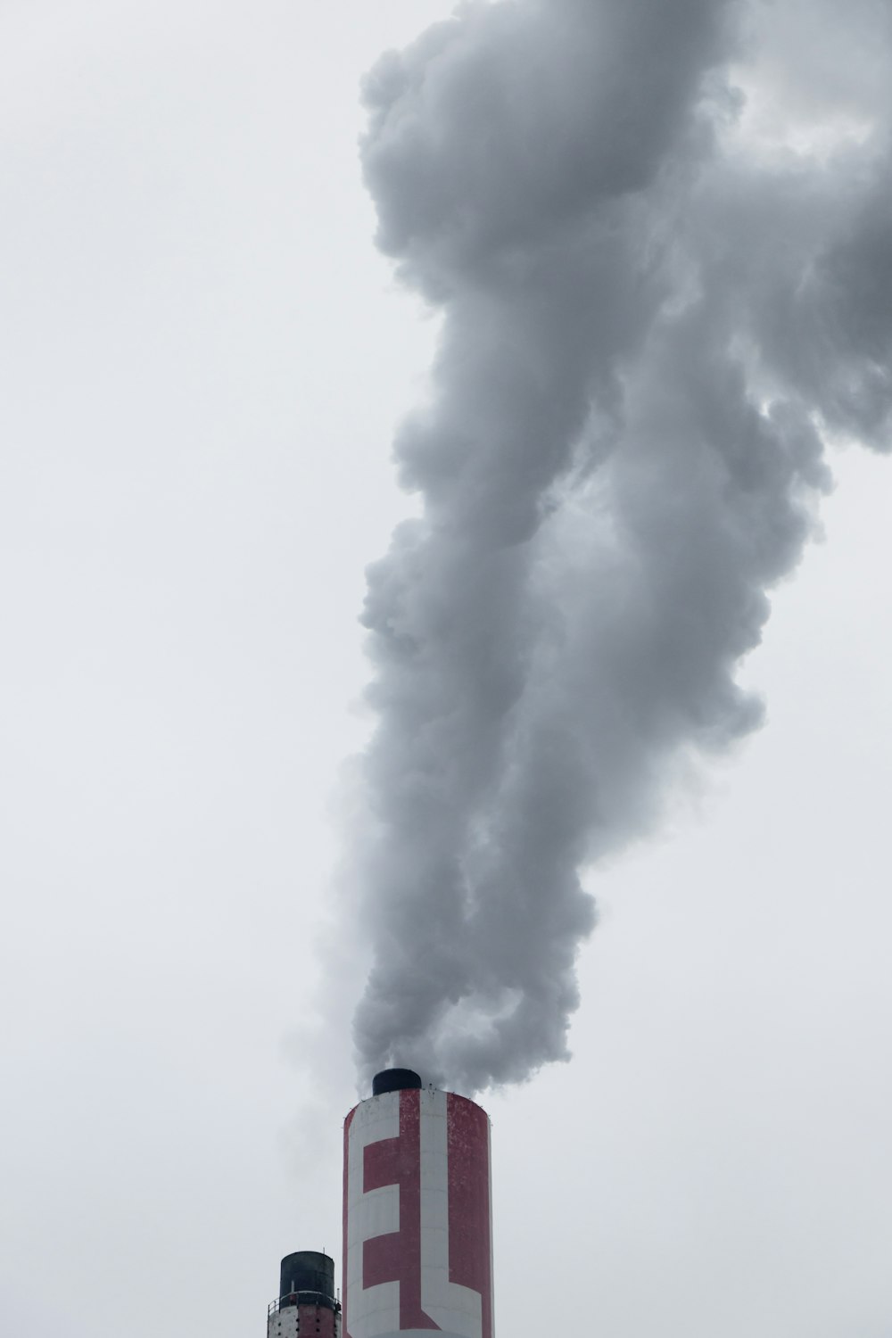 Camino rosso della fabbrica con fumo