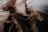 Long, flowing hair is captured in motion against a blurred background. The strands of hair have a natural mix of colors ranging from dark brown to lighter blond shades. The motion suggests a dynamic and free-spirited moment.