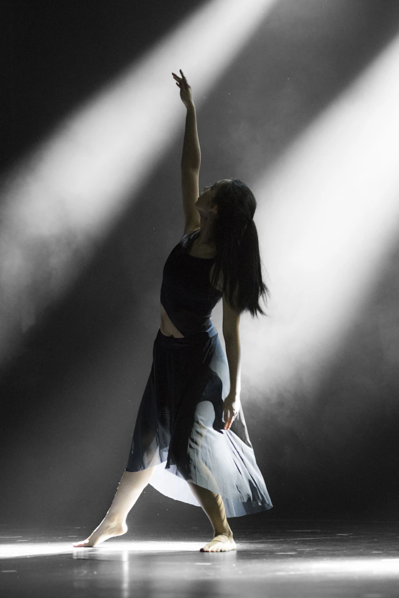A dancer stretching by the studio window