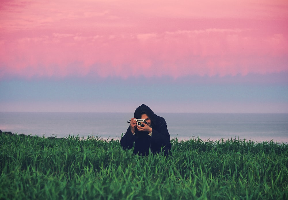 man standing on grass field