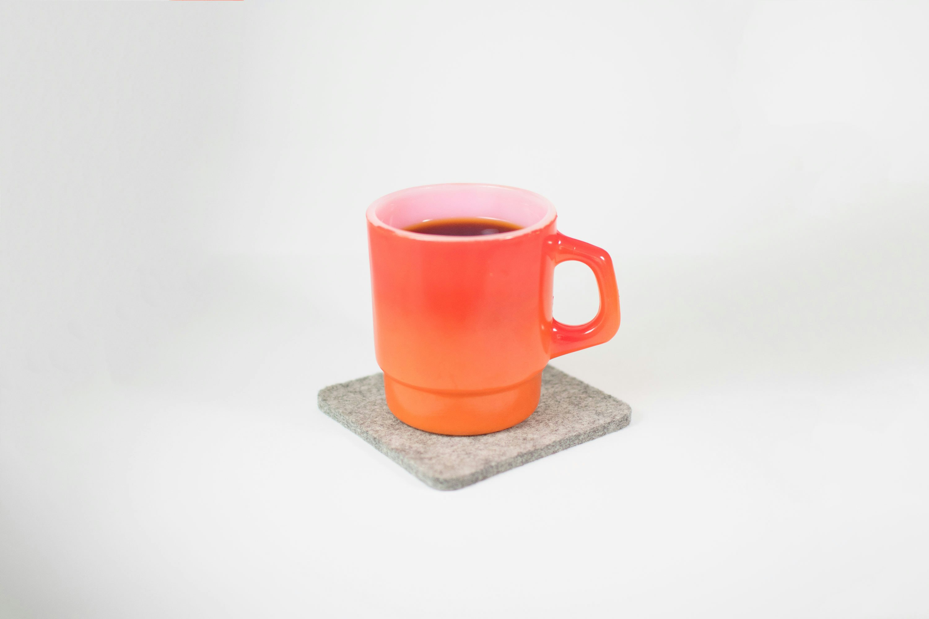 orange mug filled with black liquid