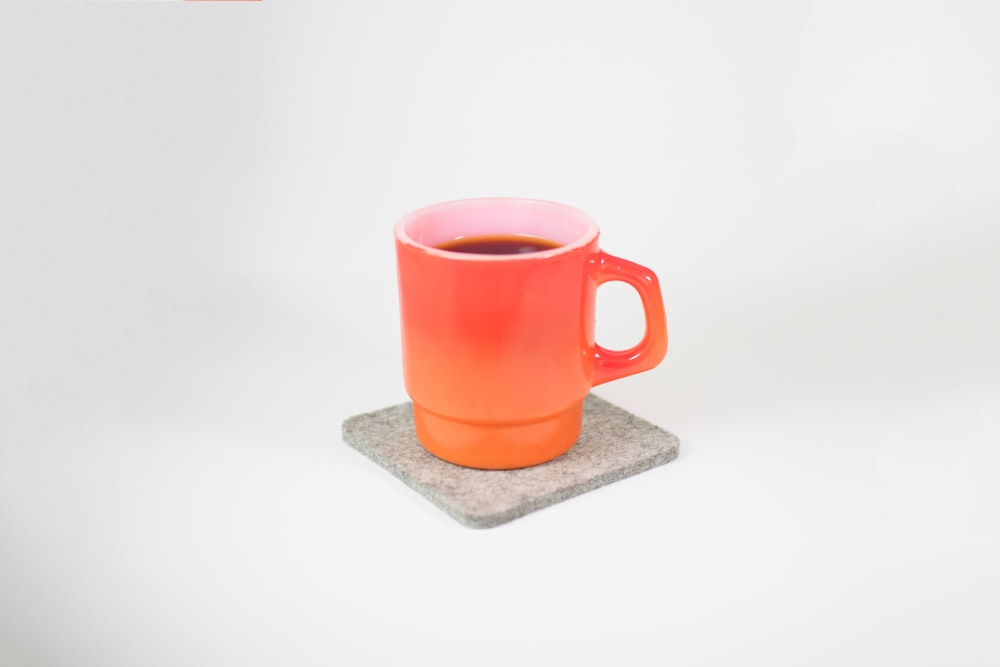 orange mug filled with black liquid