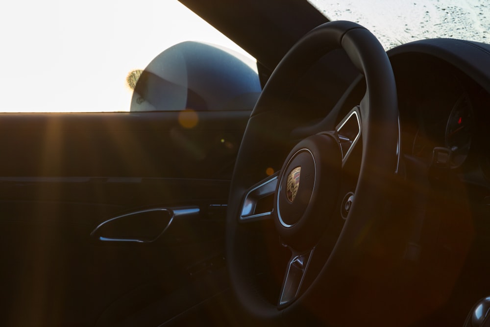 black Porsche vehicle steering wheel