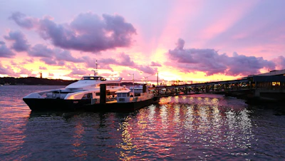 A panoramic shot of the Huracan Yacht 35s cruising with a vibrant sunset highlighting its color options.