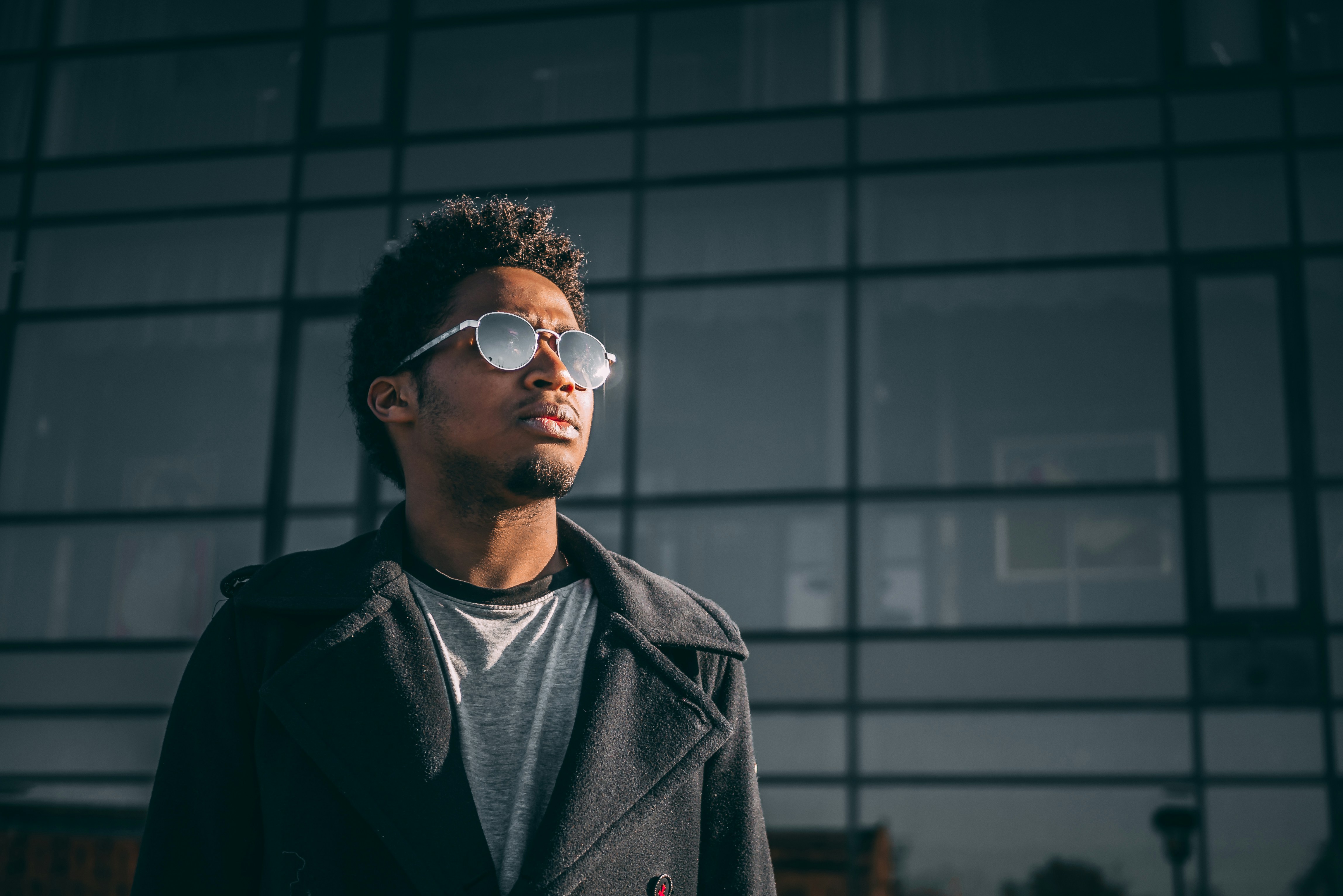 man standing in front of a glass wall