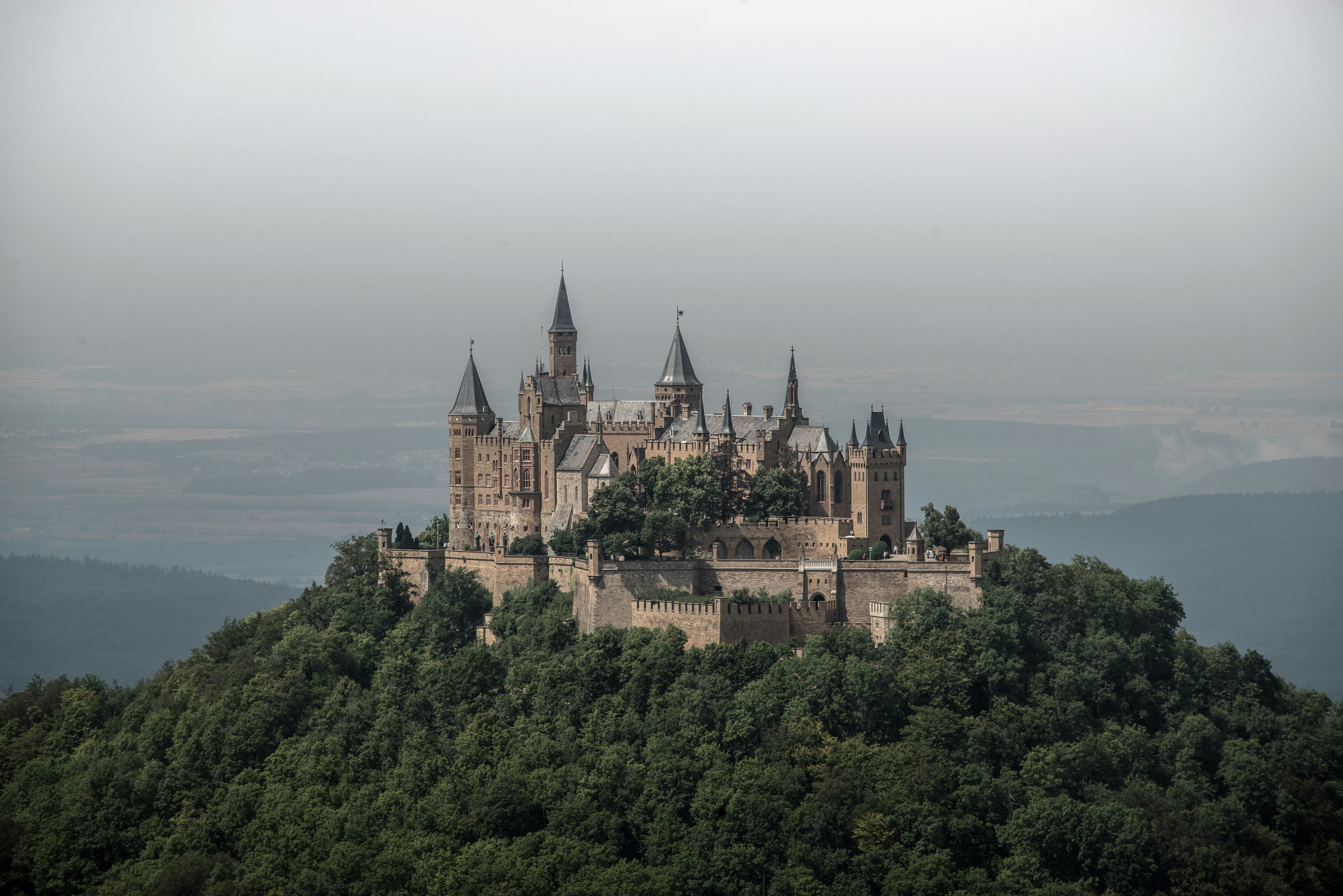 grey and white castle on hills