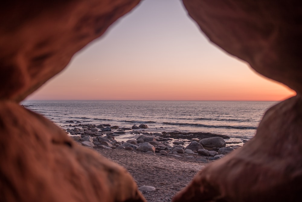 shallow focus photography of stones beside water