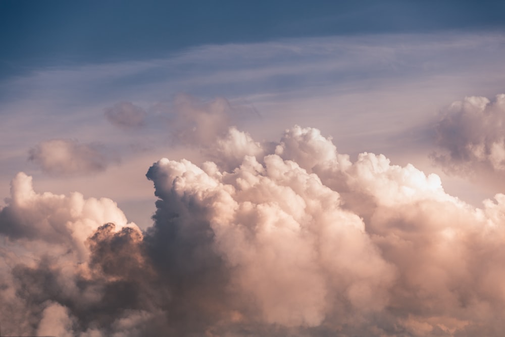 white clouds under blue skies