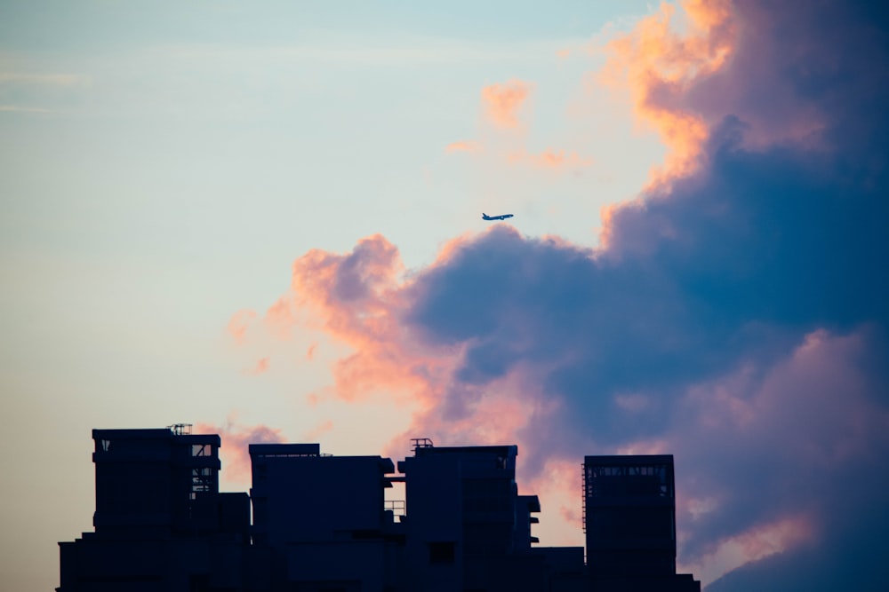 silhouette of buildings against clouds