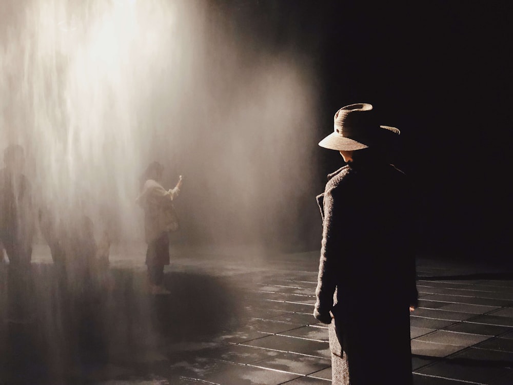 man standing in front of water