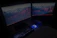 A sleek ultrawide monitor setup with glowing neon blue accents in a dark room.