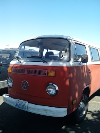A restored classic VW bus parked outdoors, showcasing a fresh engine conversion.