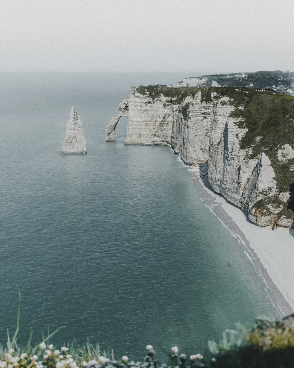 white mountain beside ocean during daytime