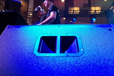 A lively karaoke speaker setup with microphone and vibrant stage lights.