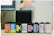 A row of eight film canisters are aligned on a surface. The canisters feature various colorful labels from different brands, including Agfa Vista, CVS Color Film, and Ilford Pan. The background appears slightly blurred with neutral tones, indicating a focus on the film canisters.