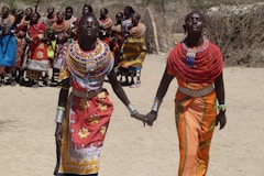 two women holding hands each other