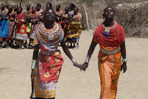 two women holding hands each other