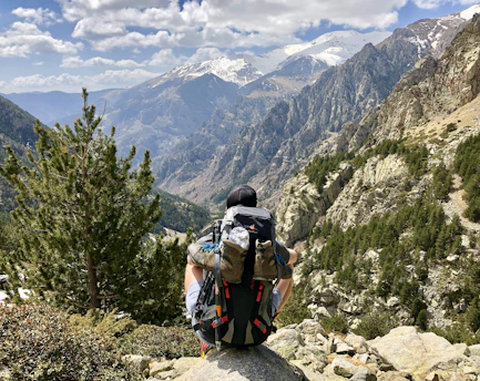 A traveler reviewing a detailed itinerary with a scenic mountain backdrop.