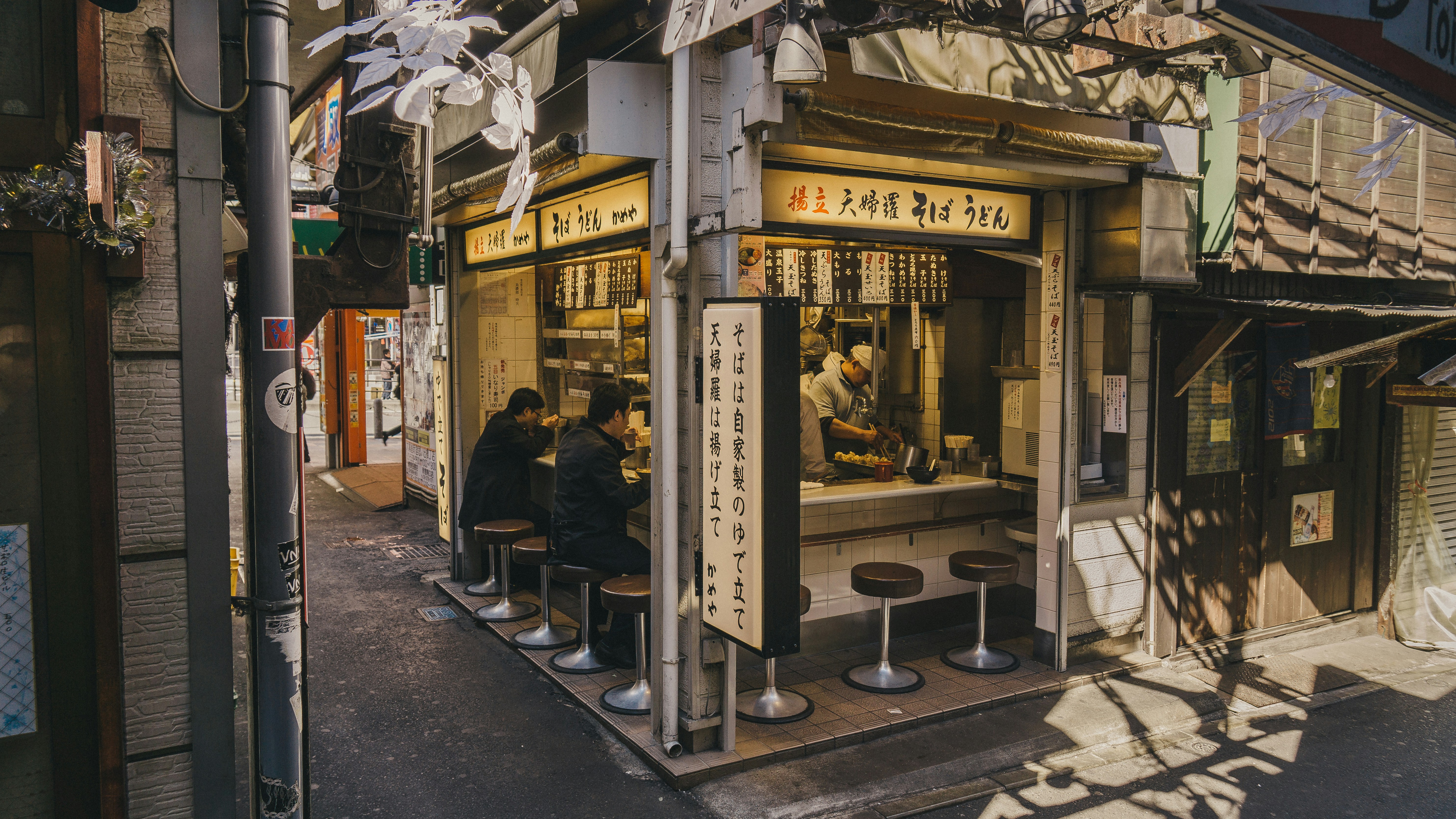 people eating inside stall beside street