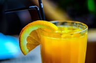 A refreshing glass of fruit juice with ice cubes.