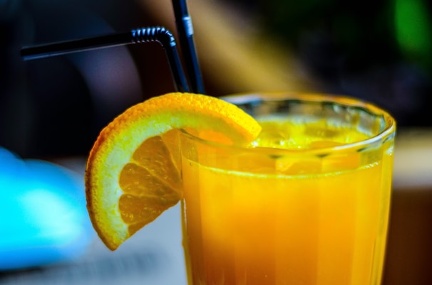 A refreshing glass of freshly squeezed orange juice with ice and mint.