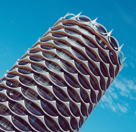 Modern architectural blueprint overlaying a sleek building facade.